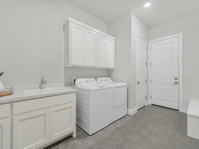 laundry room featuring recessed lighting, light tile patterned floors, a sink, separate washer and dryer, and cabinet space