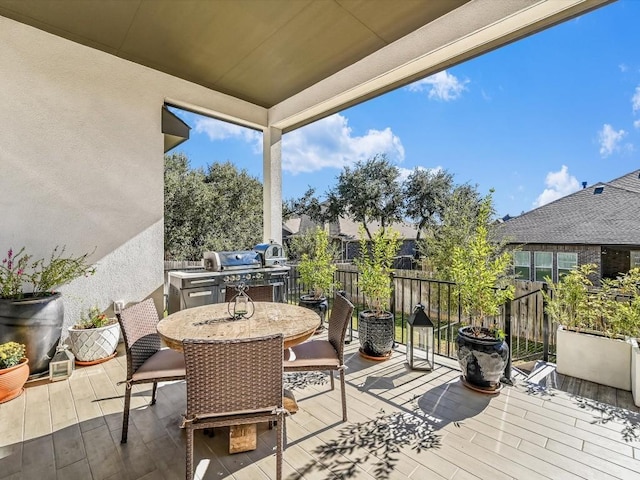 wooden terrace with fence and outdoor dining space