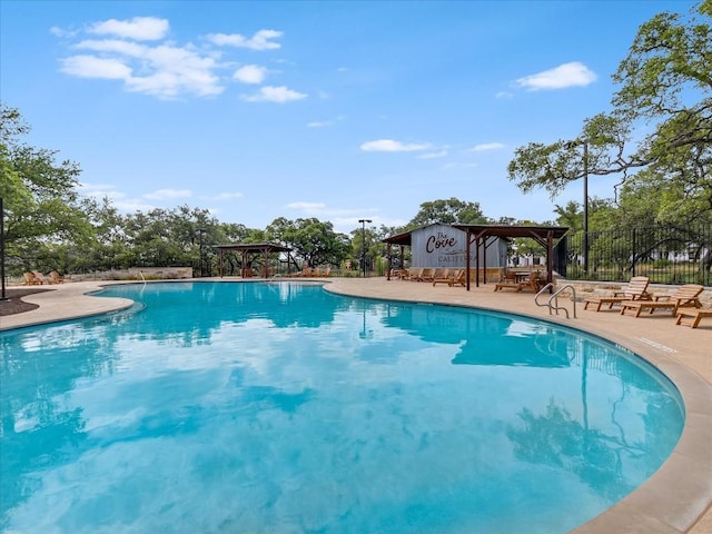 pool with fence, a gazebo, and a patio