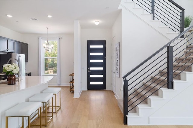 4323 Attra St, Austin, TX 78723 - entrance foyer with light wood-style flooring, visible vents, recessed lighting, a notable chandelier, and stairs