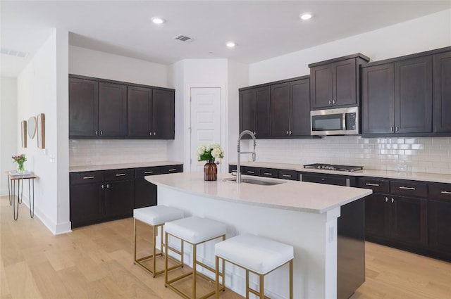 4323 Attra St, Austin, TX 78723 - kitchen with light wood-style flooring, visible vents, appliances with stainless steel finishes, and a sink