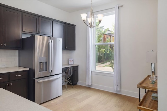 4323 Attra St, Austin, TX 78723 - kitchen with light countertops, stainless steel fridge, light wood-style floors, and tasteful backsplash