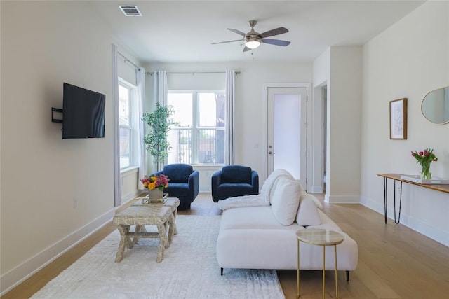 4323 Attra St, Austin, TX 78723 - living area with ceiling fan, baseboards, wood finished floors, and visible vents