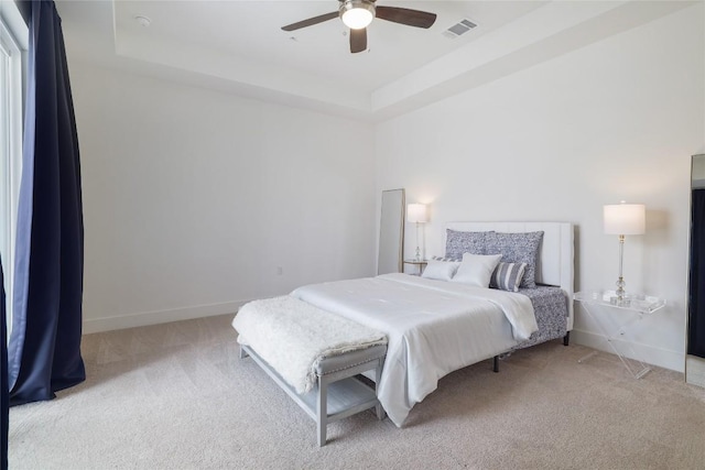4323 Attra St, Austin, TX 78723 - bedroom with ceiling fan, a raised ceiling, light colored carpet, baseboards, and visible vents