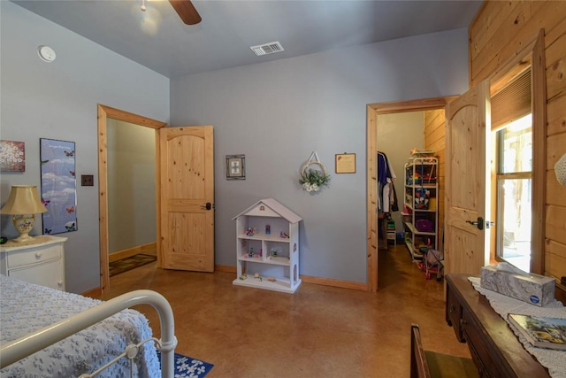 bedroom featuring a ceiling fan, a closet, a spacious closet, baseboards, and visible vents