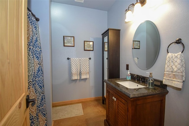 full bathroom featuring baseboards and vanity