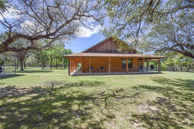 exterior space featuring covered porch, a yard, board and batten siding, and log siding