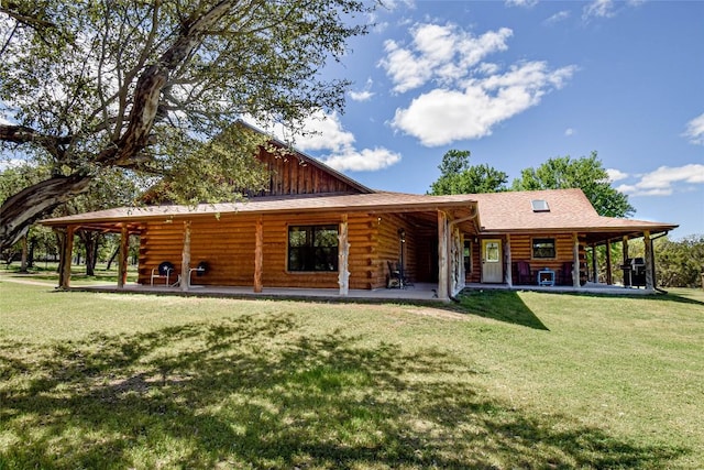 rear view of house featuring a yard and log exterior