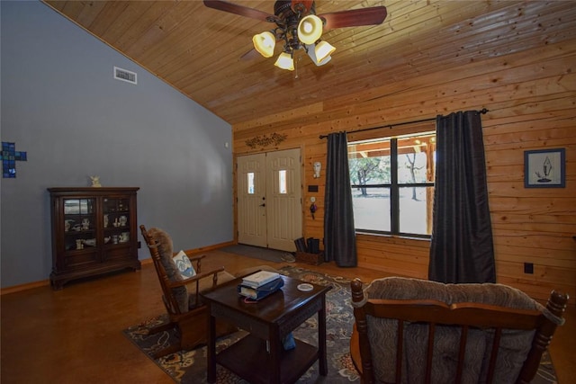 living room with wooden ceiling, baseboards, visible vents, a ceiling fan, and wooden walls
