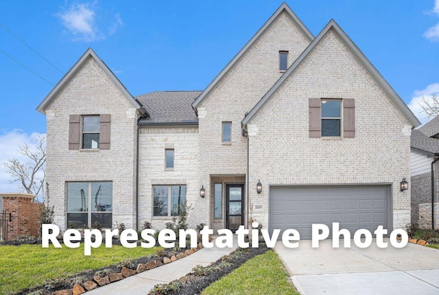 7413 Desert Needle Dr, Lago Vista, TX 78645 - french country inspired facade featuring brick siding, concrete driveway, and a garage