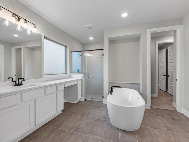 7413 Desert Needle Dr, Lago Vista, TX 78645 - bathroom with tile patterned flooring, vanity, a shower stall, a soaking tub, and recessed lighting
