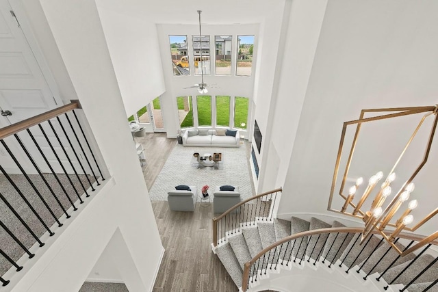 7413 Desert Needle Dr, Lago Vista, TX 78645 - stairs featuring a high ceiling, wood finished floors, and a ceiling fan