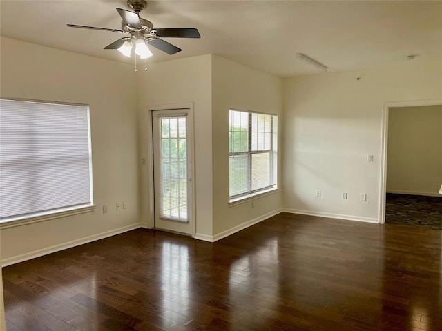empty room featuring baseboards, a ceiling fan, and wood finished floors