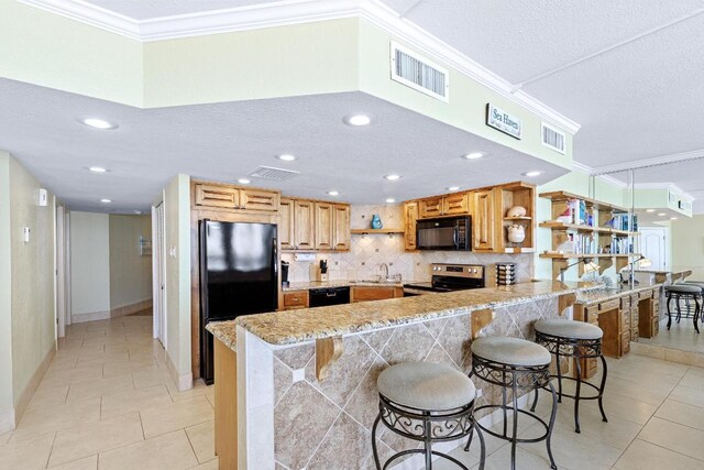 kitchen with black appliances, light tile patterned flooring, open shelves, and visible vents
