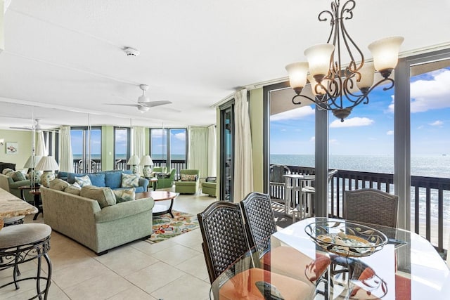 sunroom / solarium with plenty of natural light, a water view, and an inviting chandelier
