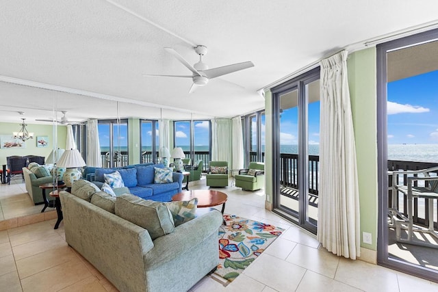 living area with a wall of windows, a water view, a ceiling fan, and tile patterned floors