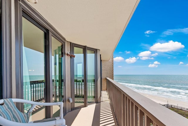 balcony with a view of the beach and a water view
