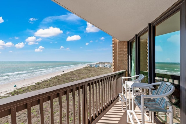 balcony with a view of the beach and a water view