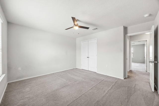7001 Midlothian Dr, Austin, TX 78754 - unfurnished bedroom featuring carpet floors, a closet, baseboards, and a ceiling fan
