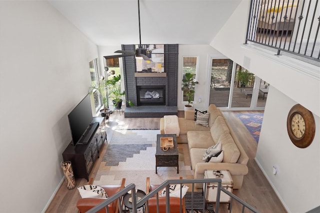 2003 Ploverville Ln, Austin, TX 78728 - living room with baseboards, a ceiling fan, wood finished floors, and a fireplace