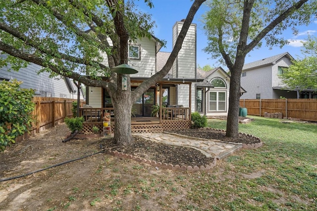 2003 Ploverville Ln, Austin, TX 78728 - back of house featuring a fenced backyard, a chimney, a yard, and a deck
