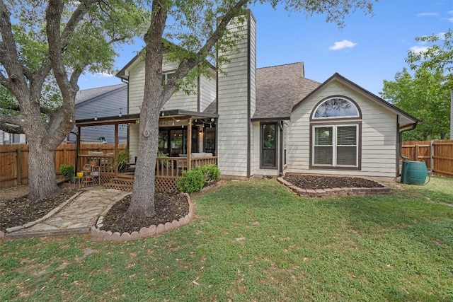 2003 Ploverville Ln, Austin, TX 78728 - back of property featuring a chimney, a fenced backyard, a yard, a wooden deck, and roof with shingles