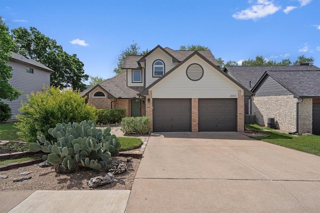 2003 Ploverville Ln, Austin, TX 78728 - traditional home featuring a garage, brick siding, central AC, and concrete driveway