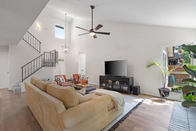 2003 Ploverville Ln, Austin, TX 78728 - living room featuring stairway, high vaulted ceiling, a ceiling fan, wood finished floors, and baseboards