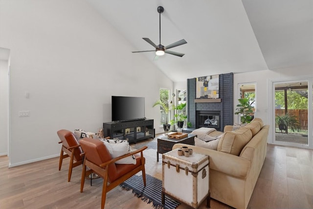 2003 Ploverville Ln, Austin, TX 78728 - living room with light wood-style flooring, high vaulted ceiling, a ceiling fan, and a fireplace