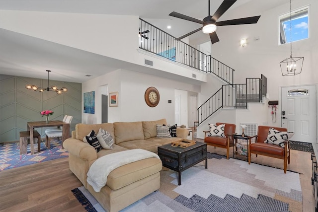 2003 Ploverville Ln, Austin, TX 78728 - living area featuring a chandelier, a high ceiling, wood finished floors, stairs, and ceiling fan