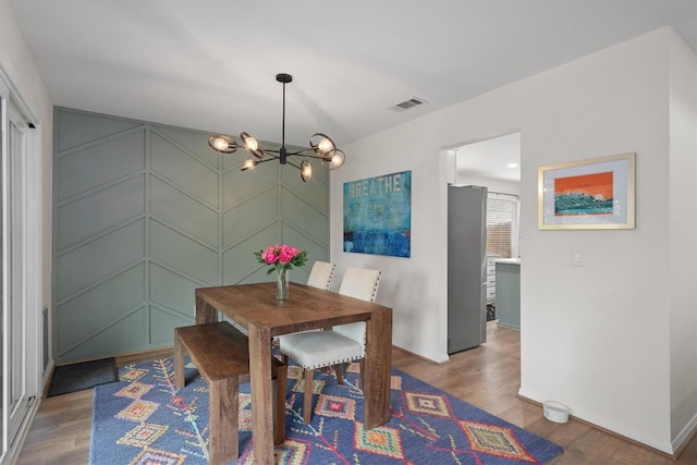 2003 Ploverville Ln, Austin, TX 78728 - dining space featuring a chandelier, wood finished floors, and a decorative wall