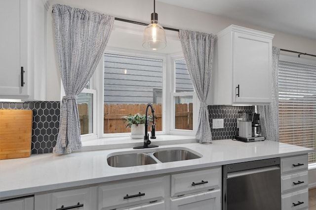 2003 Ploverville Ln, Austin, TX 78728 - kitchen featuring a sink, light countertops, backsplash, white cabinetry, and dishwashing machine