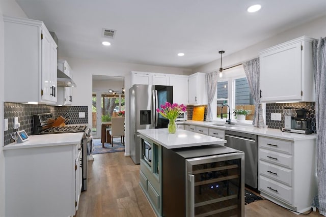 2003 Ploverville Ln, Austin, TX 78728 - kitchen with appliances with stainless steel finishes, under cabinet range hood, white cabinets, and recessed lighting