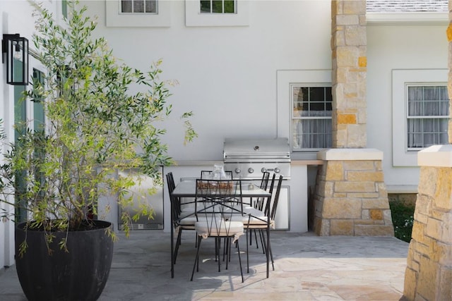 view of patio featuring exterior kitchen and outdoor dining space