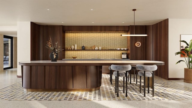 bar with wooden walls, speckled floor, bar area, and baseboards