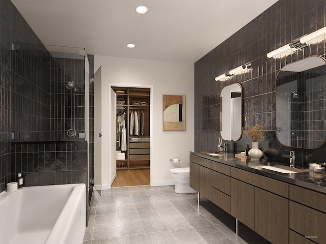 bathroom with baseboards, recessed lighting, a tile shower, and a sink