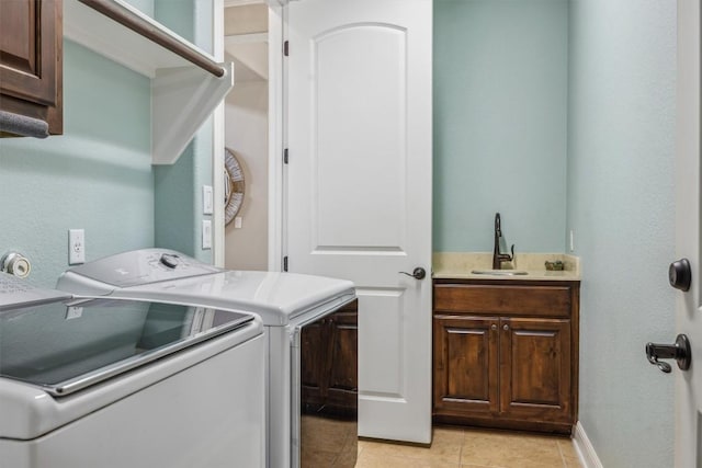 2505 Livenza Pl, Leander, TX 78641 - washroom with washer and clothes dryer, cabinet space, and light tile patterned flooring
