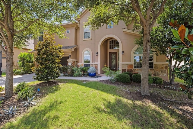 2505 Livenza Pl, Leander, TX 78641 - mediterranean / spanish-style house with stucco siding, a front yard, stone siding, driveway, and a garage
