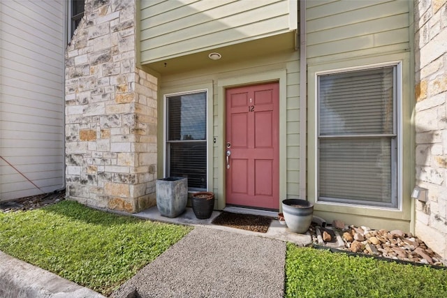 property entrance featuring stone siding