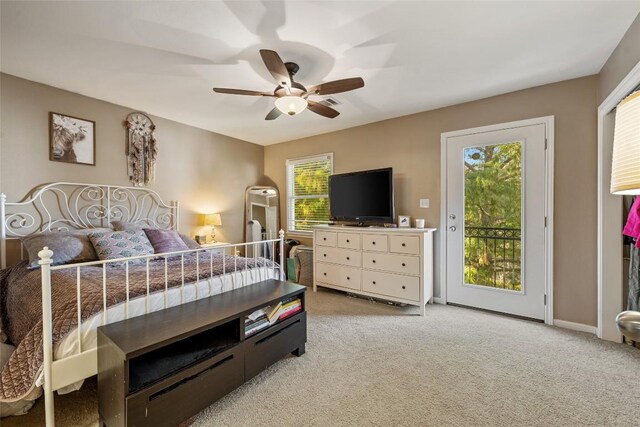 bedroom with multiple windows, light carpet, and access to exterior