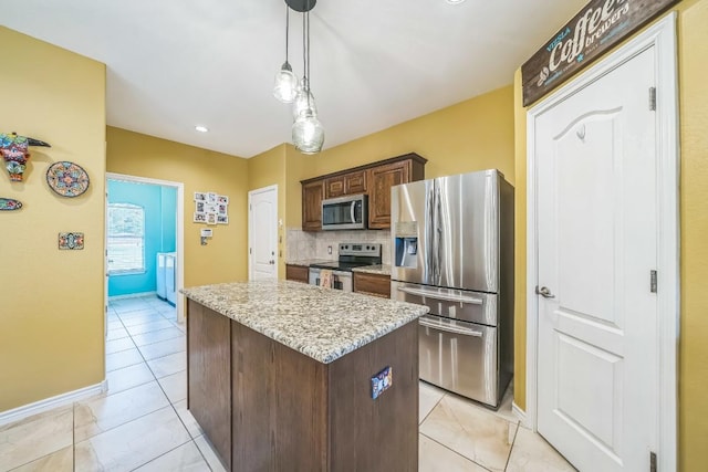 2701 Handler Holw, San Marcos, TX 78666 - kitchen with stainless steel appliances, a kitchen island, tasteful backsplash, baseboards, and pendant lighting
