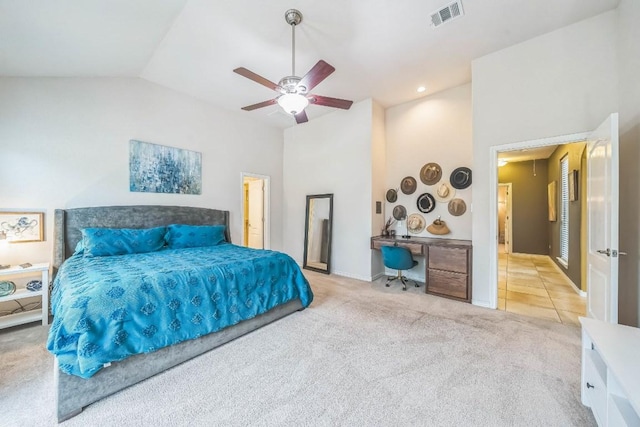 carpeted bedroom featuring vaulted ceiling, visible vents, and a ceiling fan