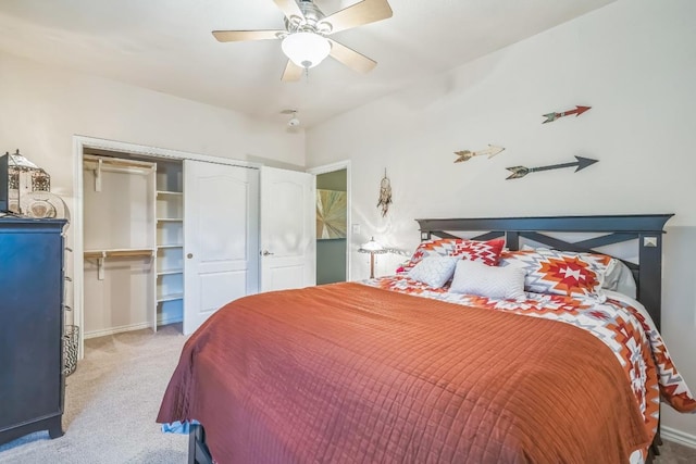 bedroom featuring light colored carpet, ceiling fan, baseboards, and a closet