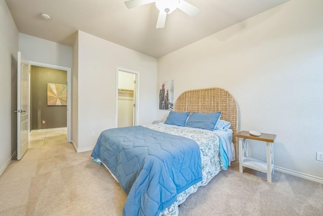 2701 Handler Holw, San Marcos, TX 78666 - bedroom featuring light carpet, baseboards, ceiling fan, and a spacious closet