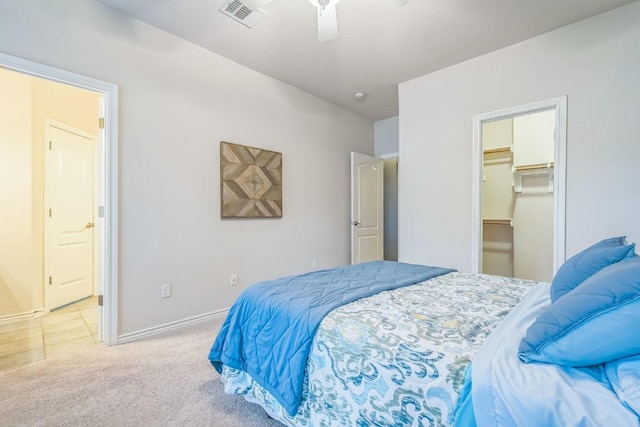 bedroom with baseboards, a ceiling fan, visible vents, and light colored carpet