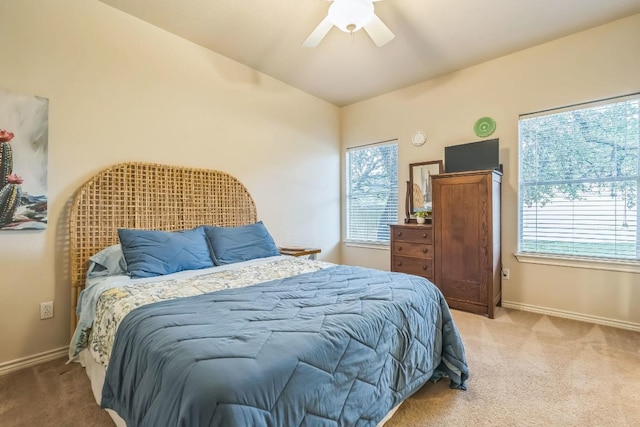 carpeted bedroom with ceiling fan, lofted ceiling, and baseboards