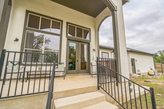property entrance featuring french doors and stucco siding