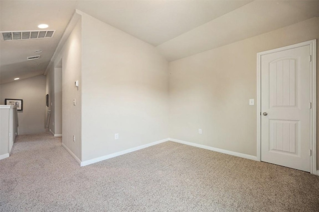 unfurnished room with baseboards, carpet flooring, vaulted ceiling, and visible vents