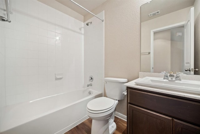 full bathroom featuring wood finished floors, shower / bathing tub combination, vanity, toilet, and visible vents