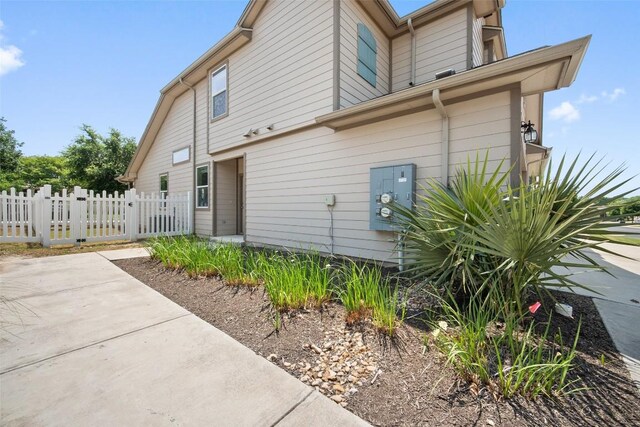 view of side of home with fence